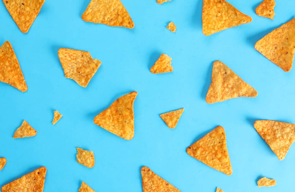 pattern mexican nachos chips on blue background top view