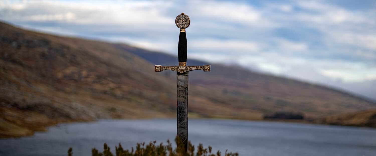 The sword excalibur is shown with lake Ogwen in the background and Tryfan to the right.