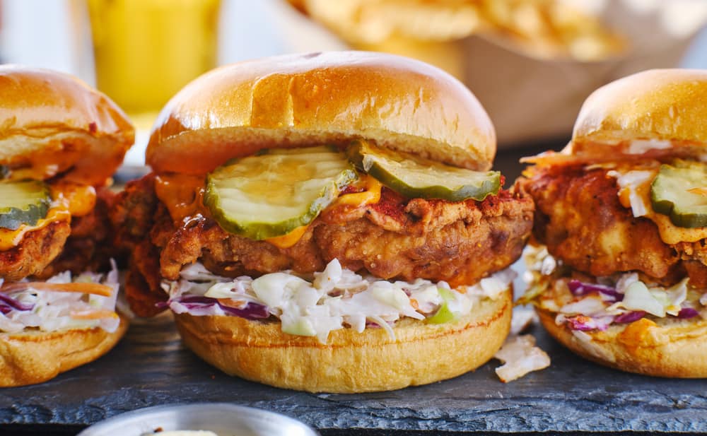 spicy nashville hot chicken sandwich with coleslaw and pickles