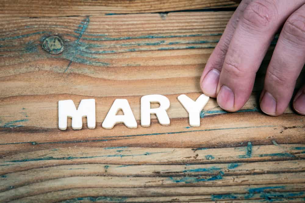 MARY. Name of women and girls. White letters of the alphabet on a wooden background.