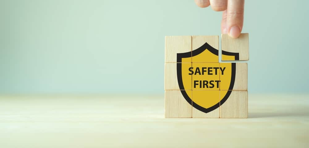 Safety first symbols, work safety, caution work hazards, danger surveillance, zero accident concept. Wooden cubes with smart grey background. Employees safety awareness at workplace. Safety banner.