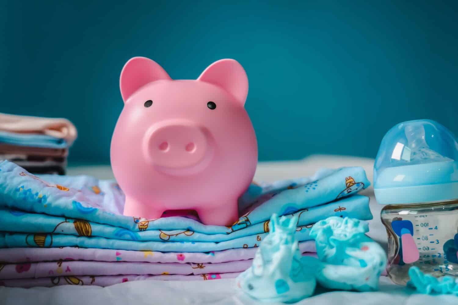 concept of Pregnancy family planning budget. Cost of having a child., piggy bank and nursery decor with savings. Maternity leave benefits. , family saving money in piggy bank