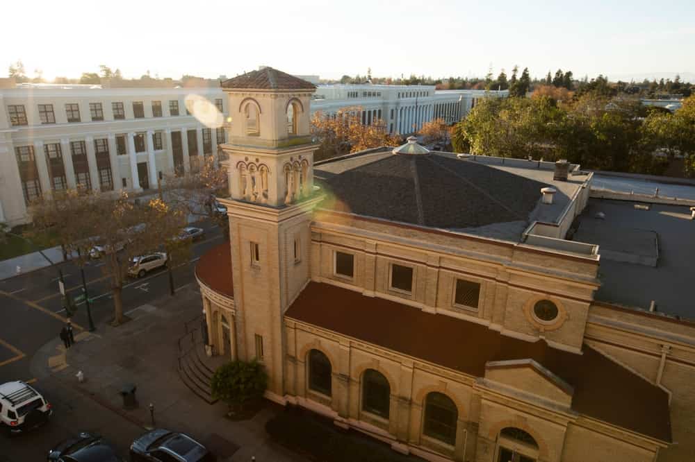Late afternoon sun shines on the historic church and downtown of the bay area city of Alameda, California, USA.