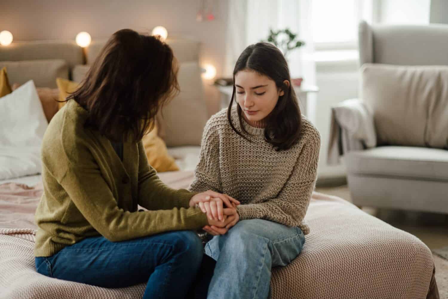 Teenage girl sharing problems with her mother.