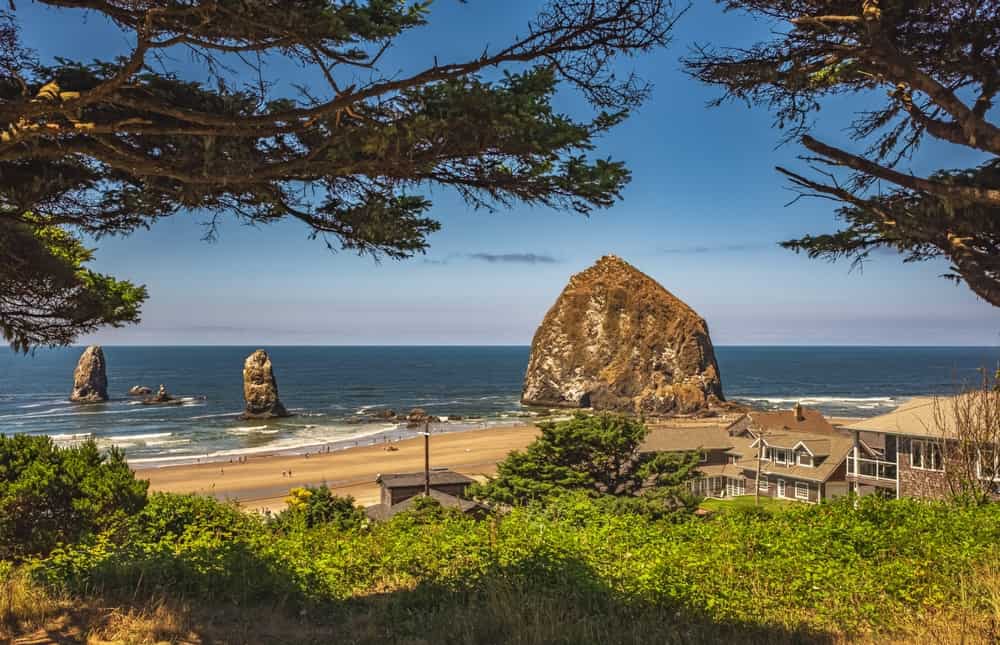Cannon Beach Landscape, Oregon USA. Cannon Beach with blue sky in the background. Rocks on a shore on a sunny summer day in Oregon Coast. Travel photo, nobody, copyspace for text