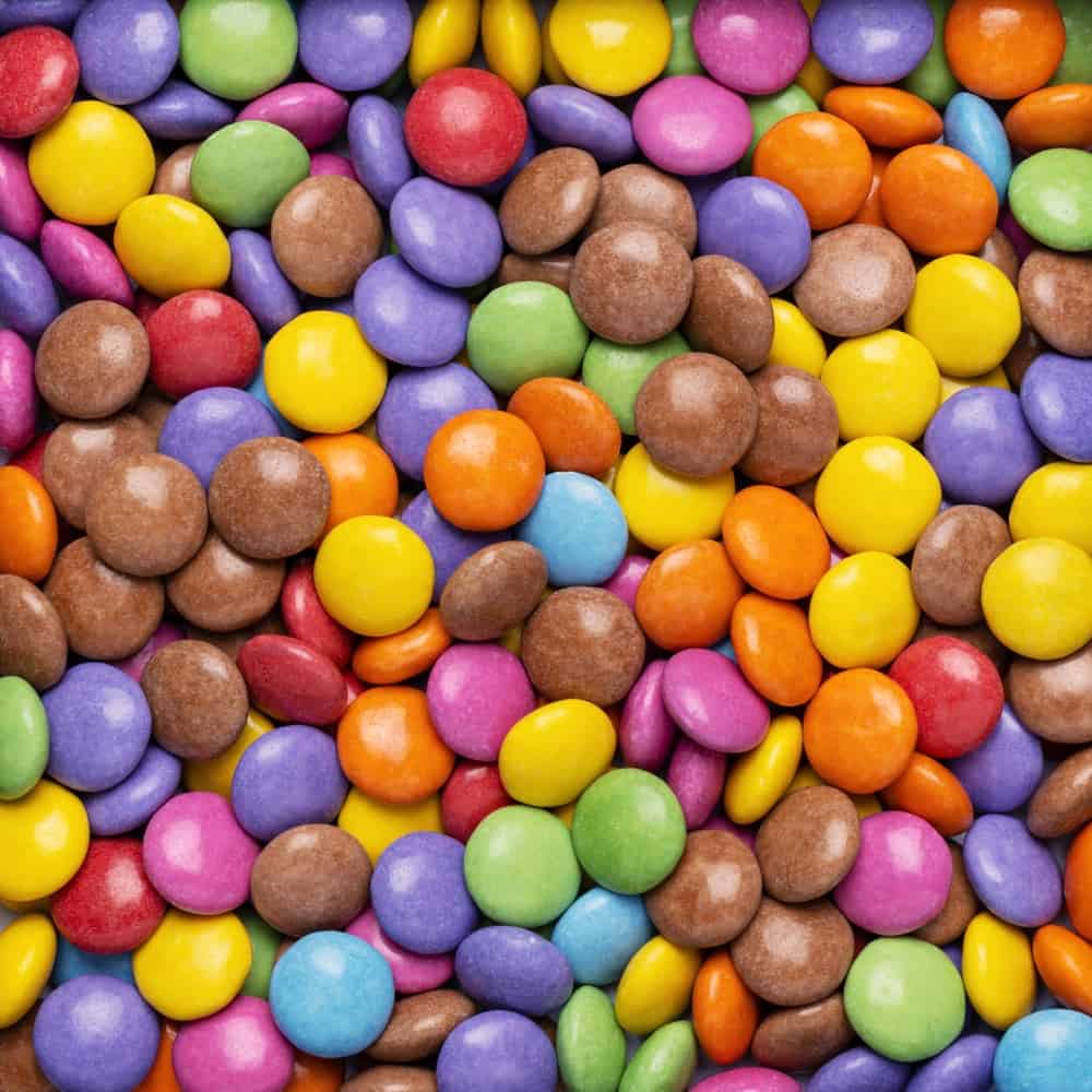 A large number of tasty-looking colored smarties filling the entire shot
