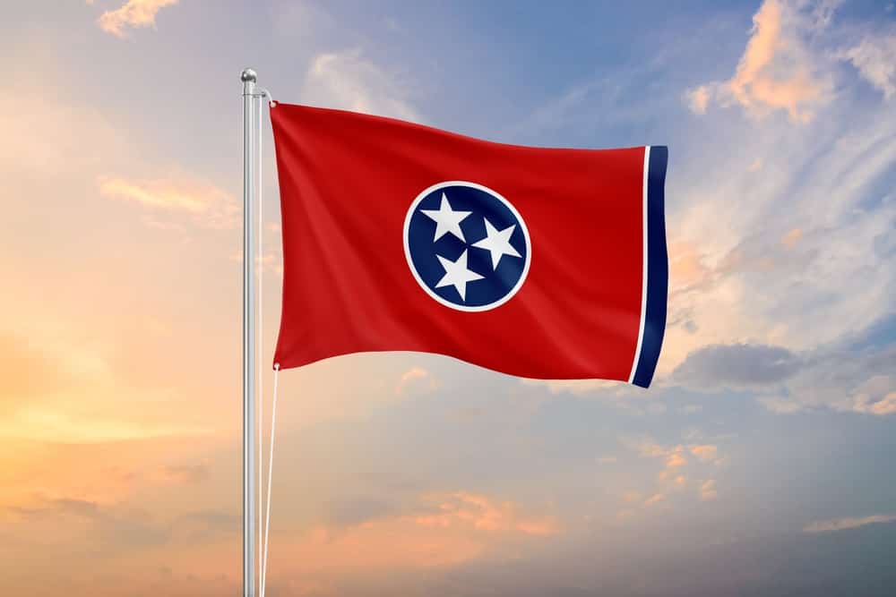 Tennessee flag waving on sundown sky