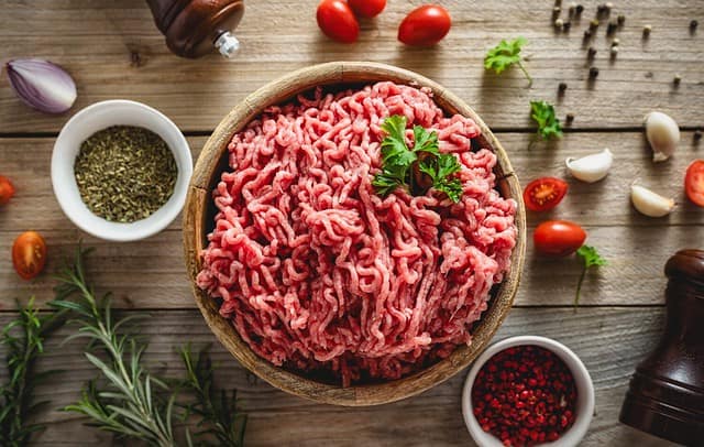 Fresh ground beef for cooking delicious and healthy food on wooden background top view