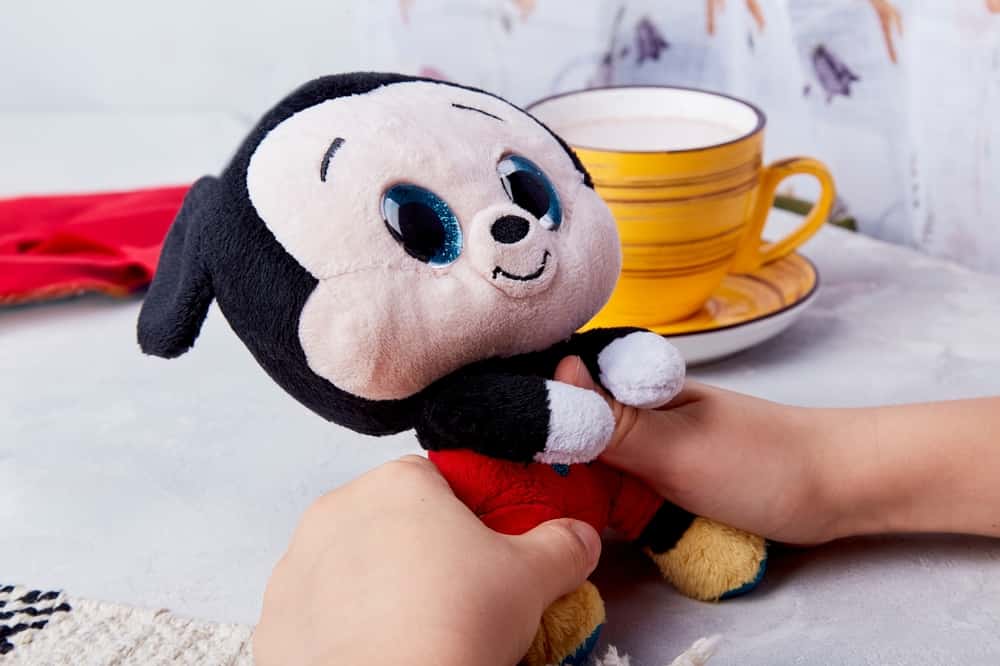 Kid plays with mickey mouse. Collectible disney magic in a toy.