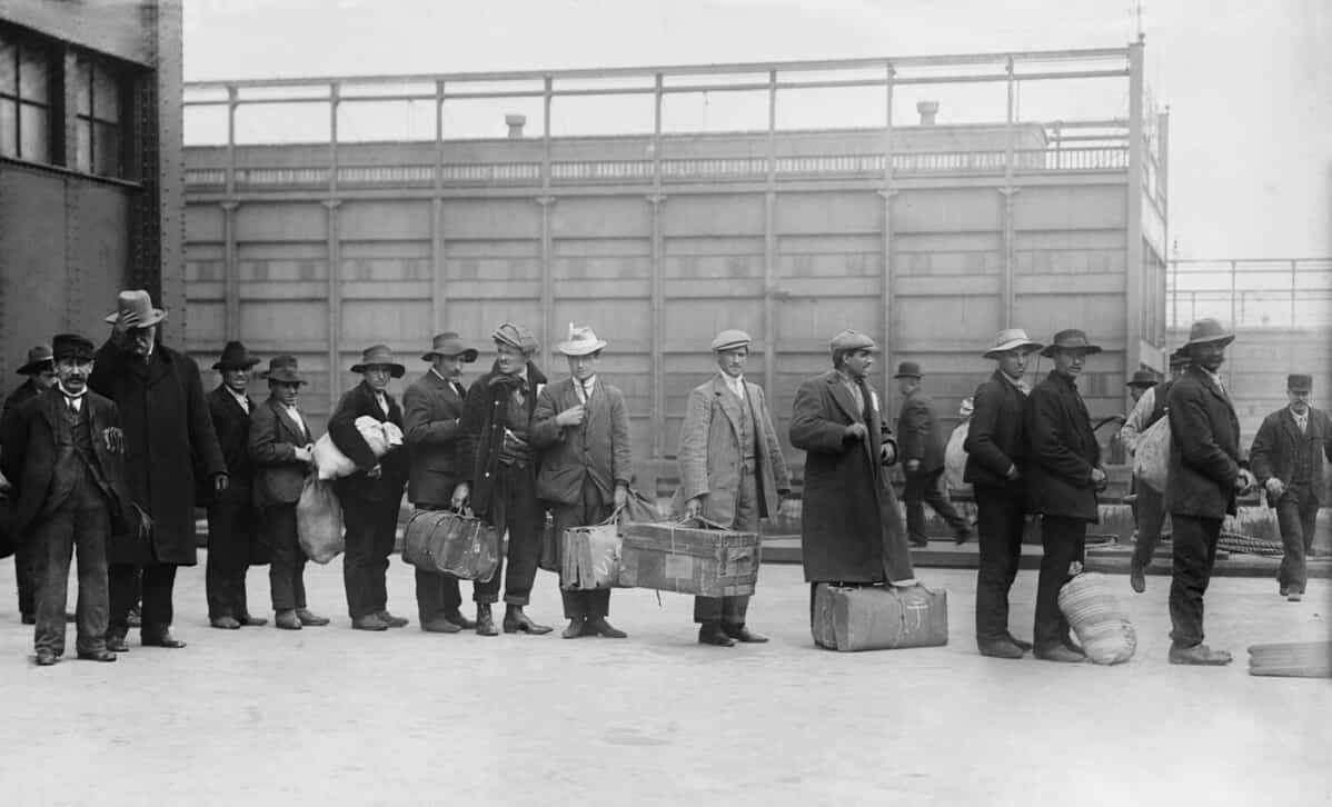 Italian men await admission processing at Ellis island, were among the 2,000 Italian immigrants the arrived on the Prinzess Irene which grounded on Fire Island sandbars. Ca. 1910.