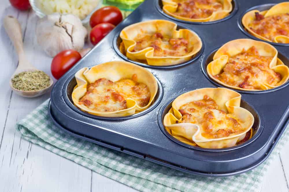 Homemade lasagna cups with minced meat, bolognese sauce topped with cheese