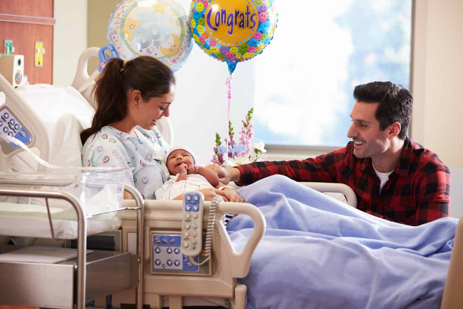 Family With New Born Baby In Post Natal Hospital Department