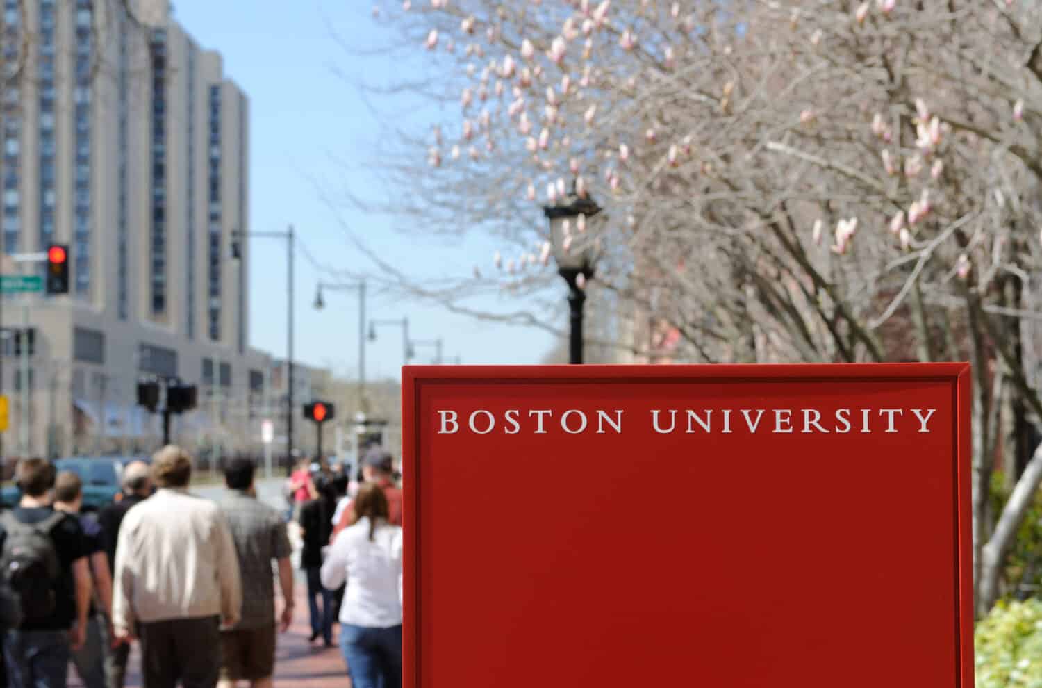Boston University sign and crowd of students walking by in early spring