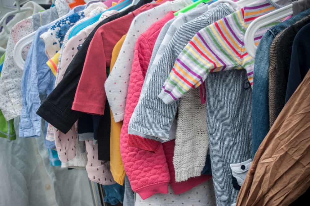 closeup of baby clothes on rack in a flea market