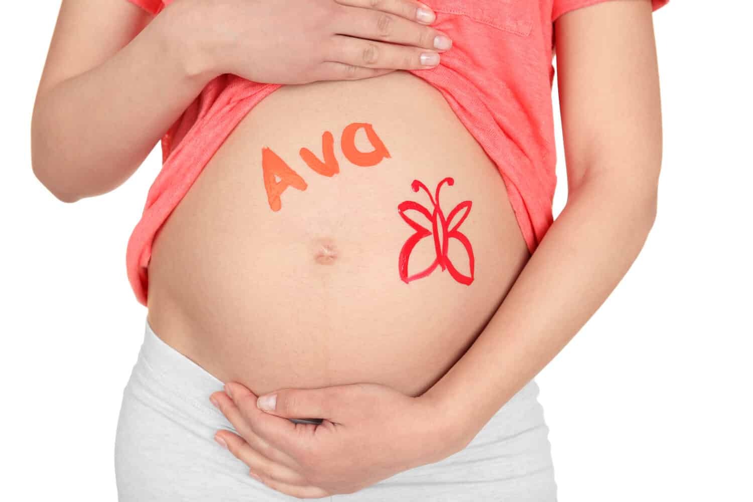 Young pregnant woman with name AVA written on her tummy, closeup. Concept of choosing baby name