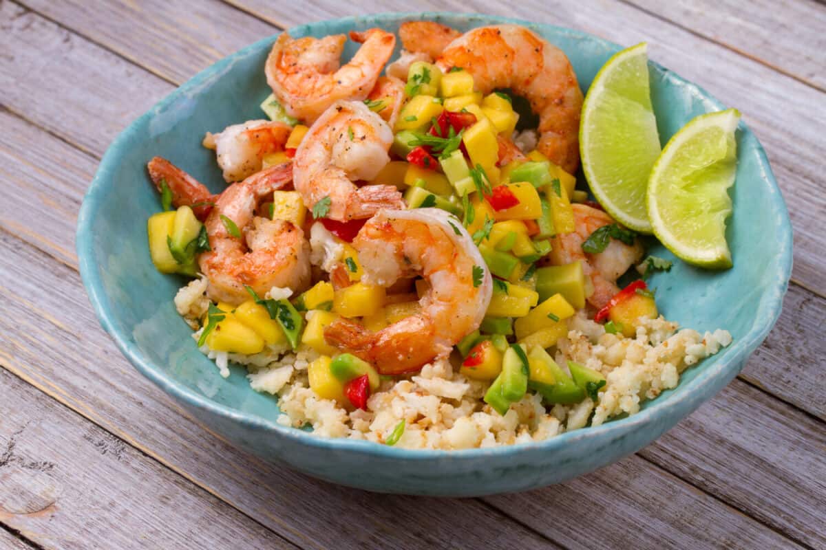 Shrimps with mango avocado and red pepper salsa on cauliflower rice