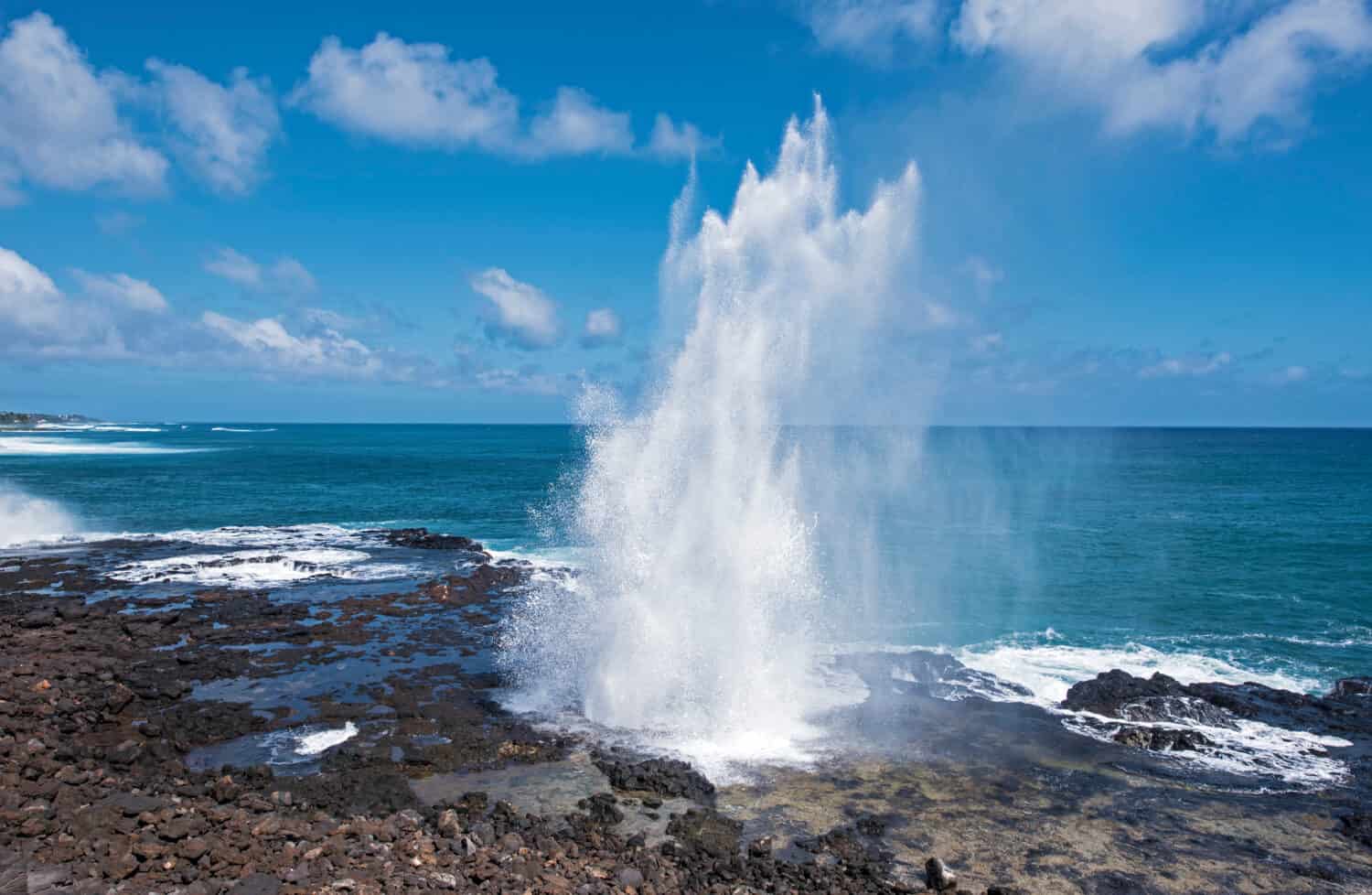 Spouting Horn is off the southern coast of Kauai in the Koloa district and is known for its crashing waves and large sprays of water.