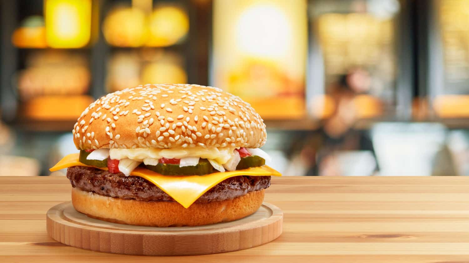 Delicious Cheese Beef Burger consists of Bun Bread, Patty, Pickle, Onion, Mayonaisse, Ketchup and Cheddar Cheese in a yellow background, with interactive 3D text for Modern Fast Food Restaurant