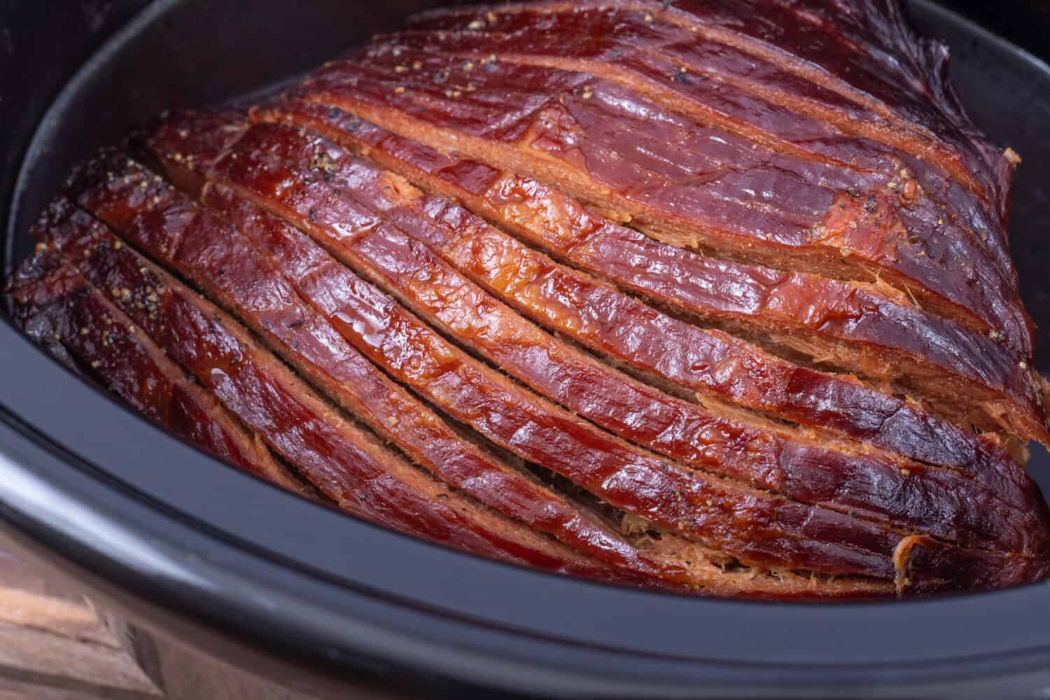 sliced ham cooked in a slow cooker closeup
