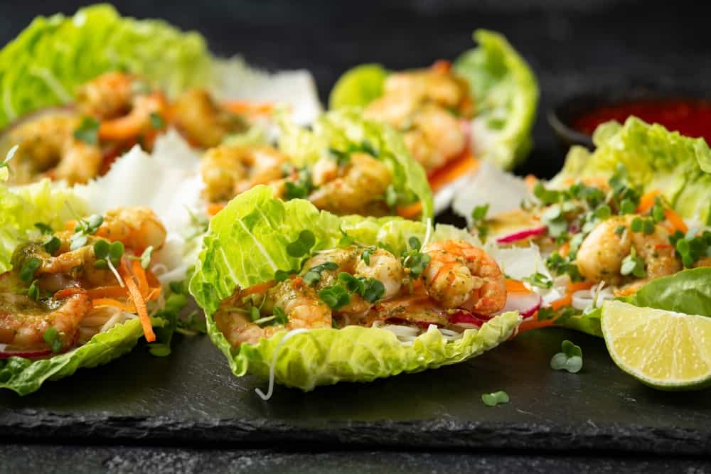 Lettuce wraps loaded with Spicy prawn, shrimp and rice vermicelli noodles, Asian style finger party food