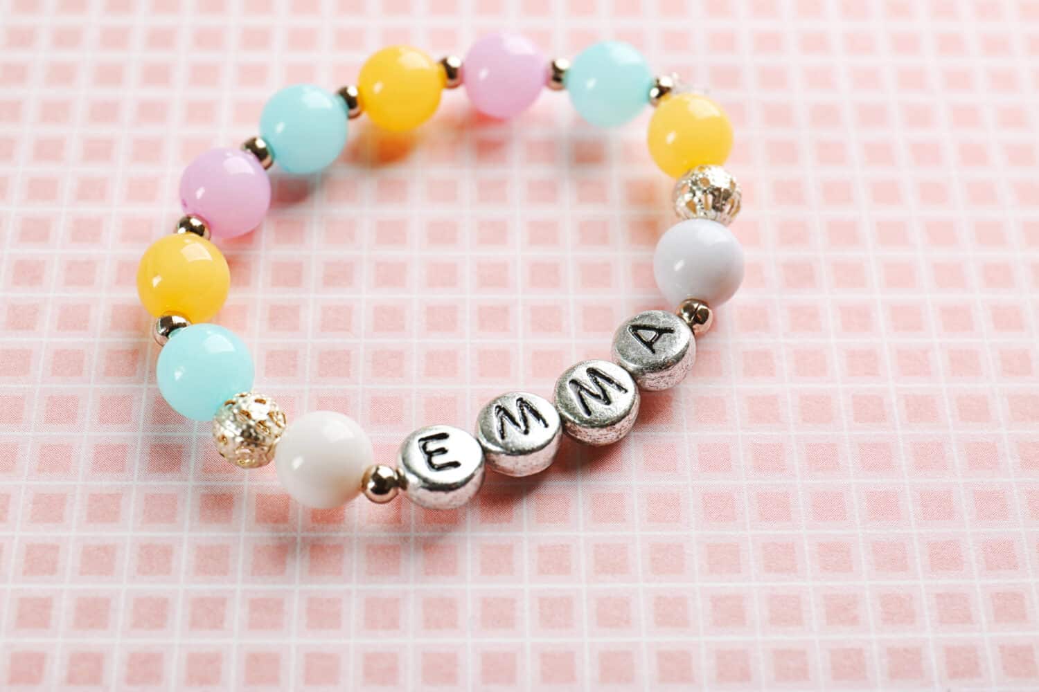 Bracelet with baby name EMMA on color cloth