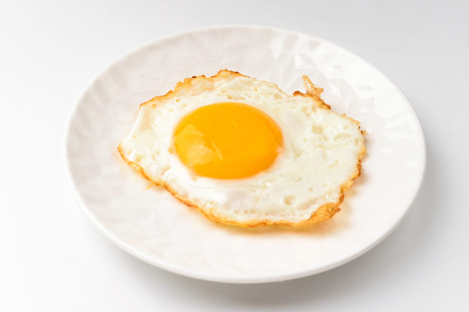 Fried eggs on white background