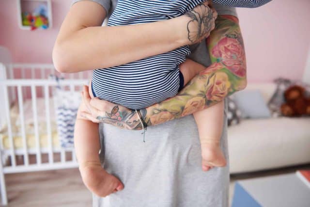Rear view of mother carrying her son