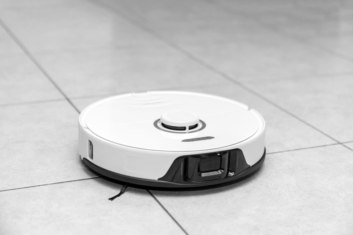 robot vacuum cleaner in modern smart home, robotic vacuum cleaner on tiles floor, Robot vacuum cleaner cleaning dust on tile floors. Modern smart cleaning technology housekeeping.	