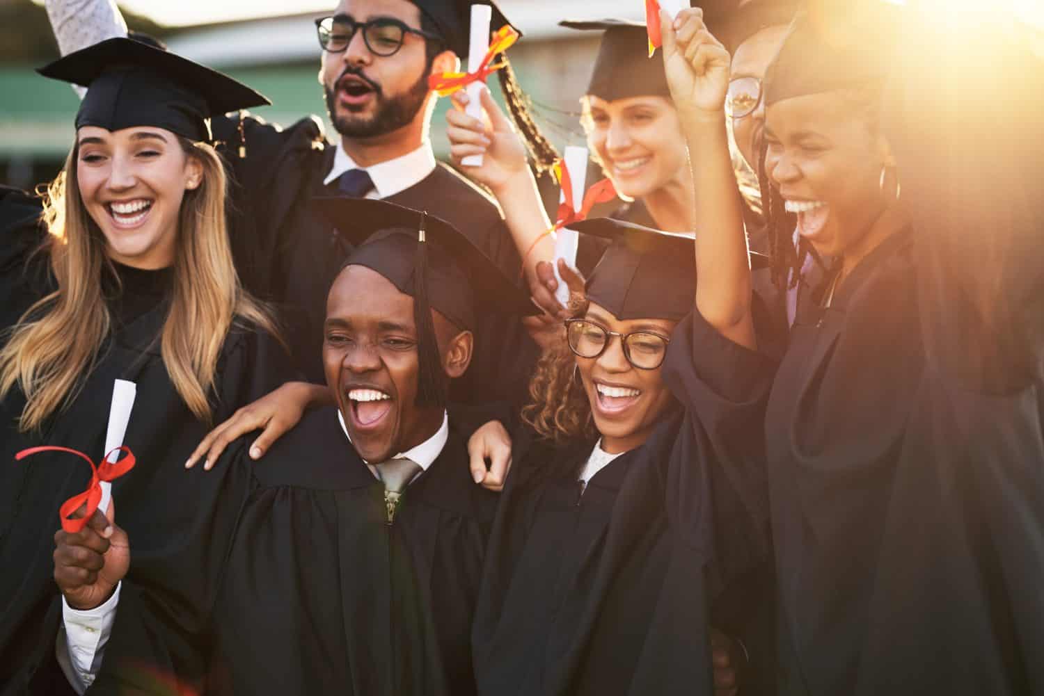 Our parents are so proud of us. Shot of a group of cheerful university students on graduation day.