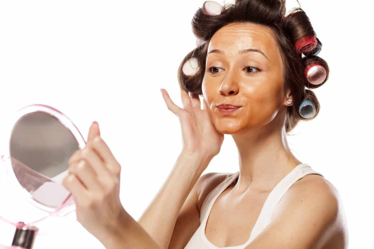 a young housewife with curlers and with wrong liquid foundation on her face