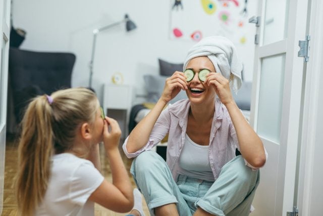 mother and daughter having great time together ta home. skin treatment concept