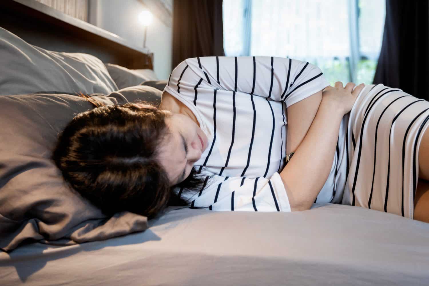 Asian middle aged woman touch belly,severe abdominal period pain,symptoms of Chocolate Cyst,Endometriosis disease,sick female having pelvic pain,acute pelvic cavity pain,Gynecology,health care concept