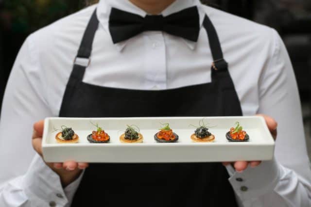 waiter with canapes / canapes with caviar / catering