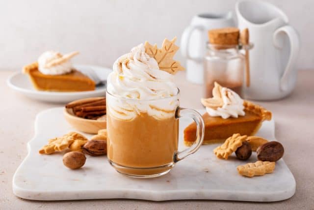 Pumpkin spice latte topped with whipped cream and dusted with cinnamon