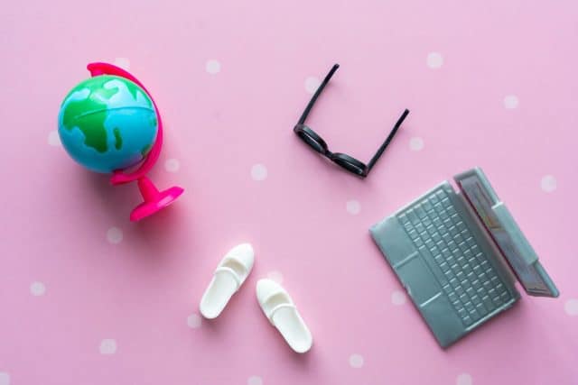 Toy black glasses, white boots, laptop and globe close-up. Back to school concept. High quality photo