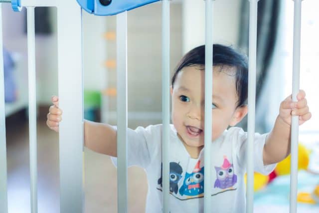 Asian baby cute boy in the safety door