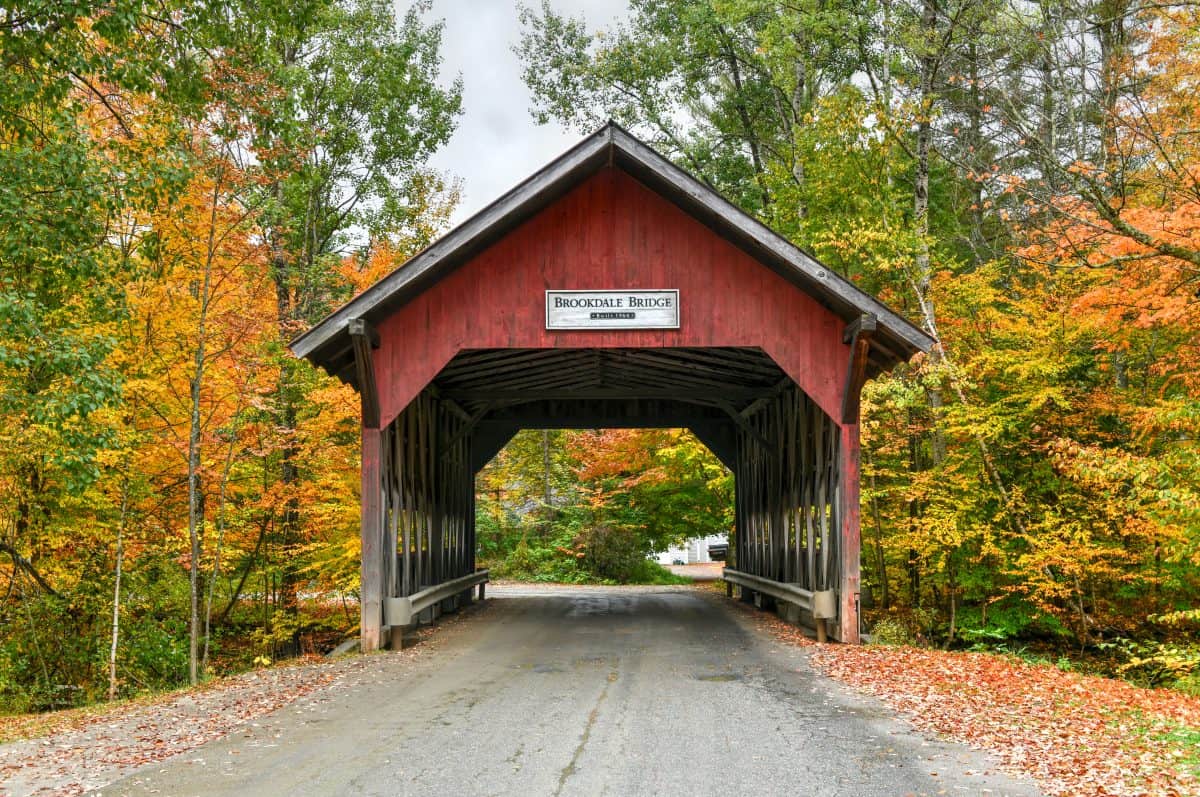 Brookdale Covered Bridge in Stowe, Vermont during fall foliage over the West Branch Little River.