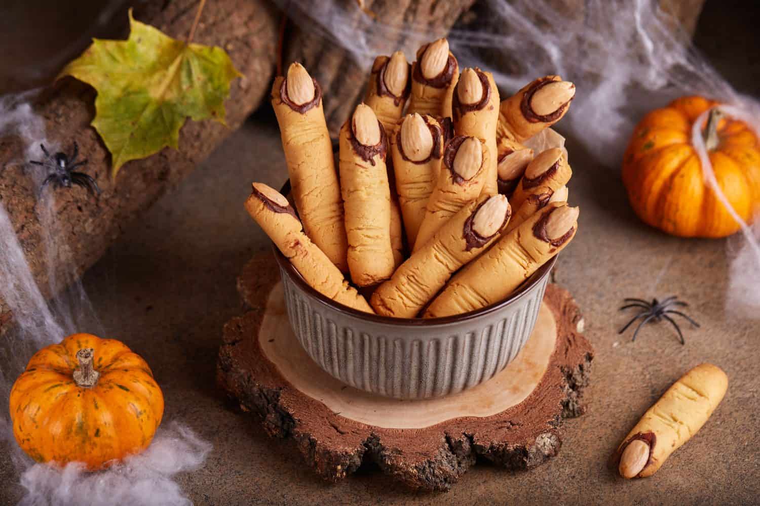 Halloween cookies witch`s fingers with chocolate and almond nuts. Delicious and scary dessert for treats.