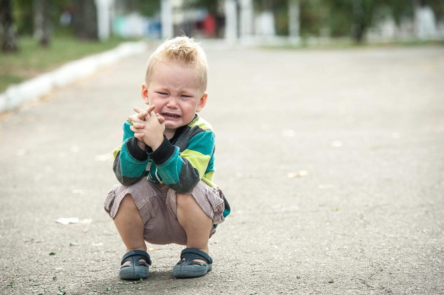 sad and unhappy child. Upset toddler boy. problem child with head in hands. concept for bullying, depression stress or frustration. Space for text. Stressed child. boy shouting. Cute boy shouts