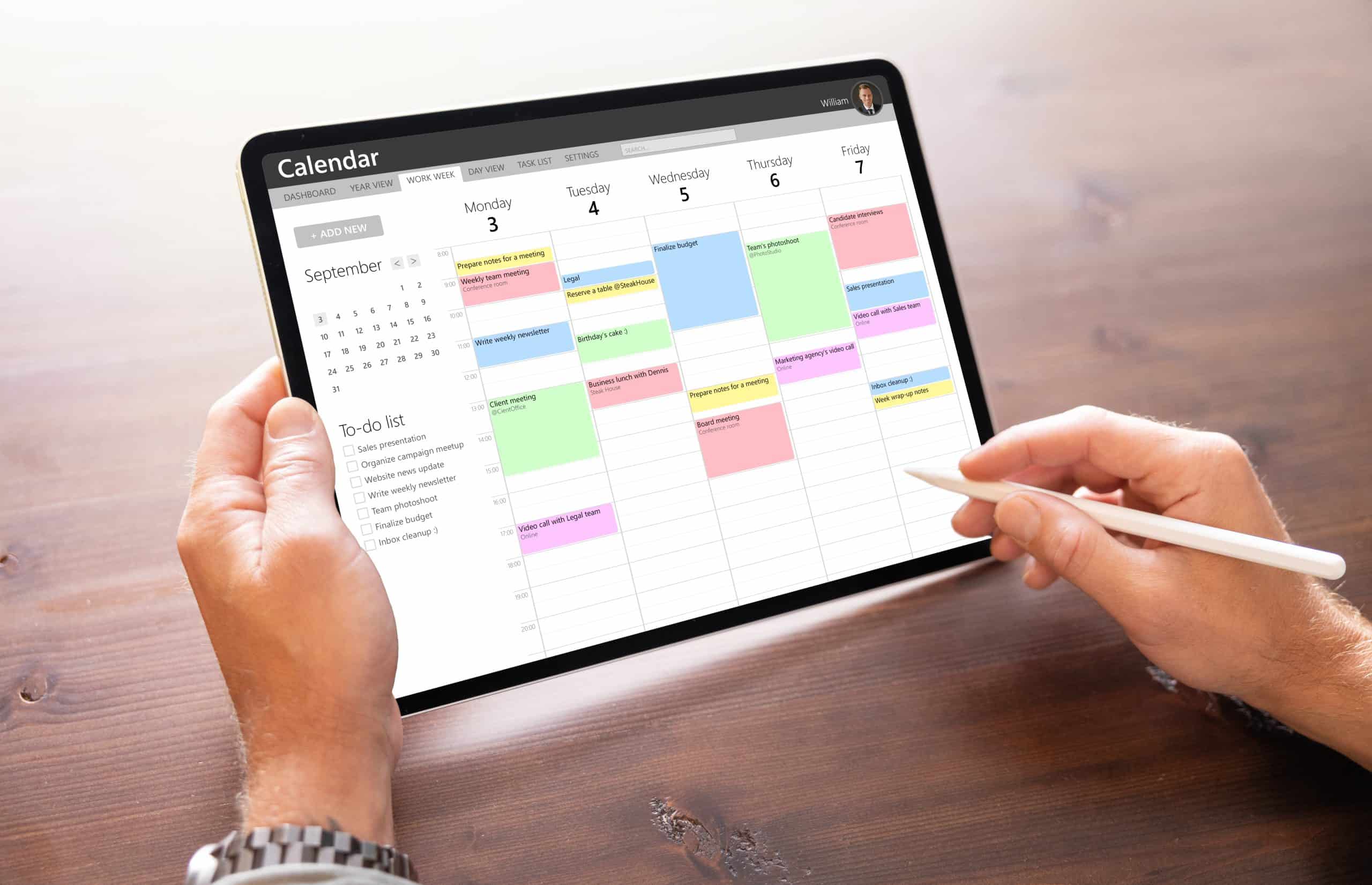 Man using calendar app on tablet computer