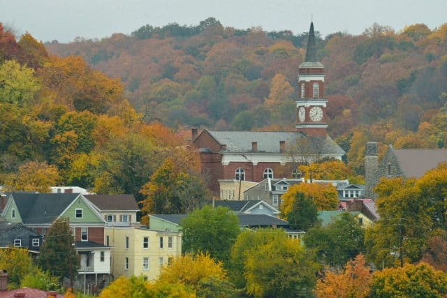 Town Clock Church and surrounding neighborhood in Cumberland Maryland on an autumn day surrounded by colorful fall foliage