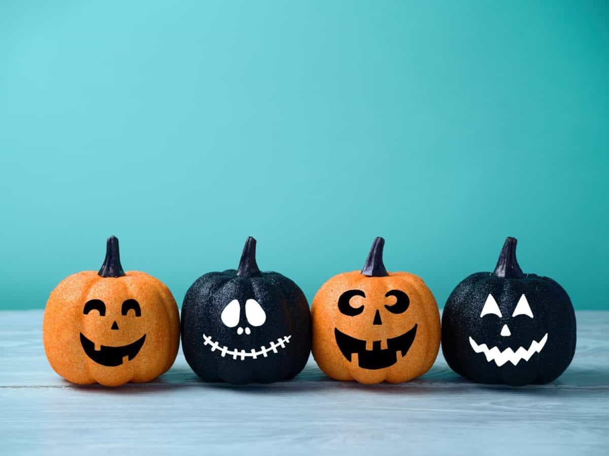 Halloween glitter pumpkin jack o lantern decor with funny faces.