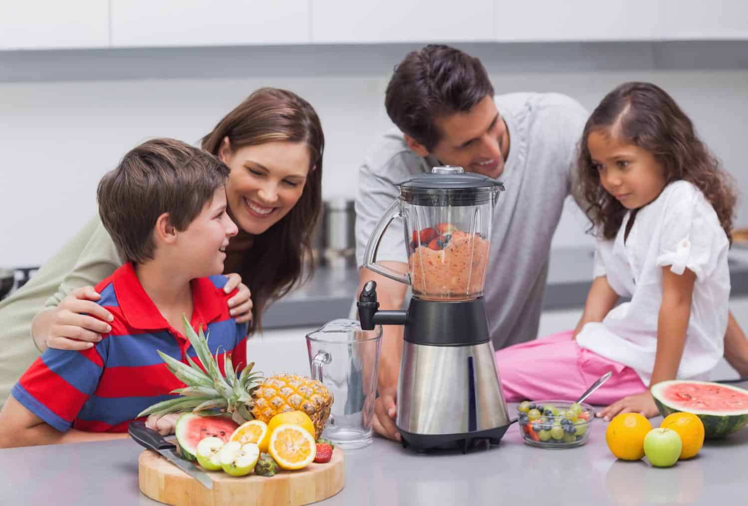 Family using a blender in the kitchen