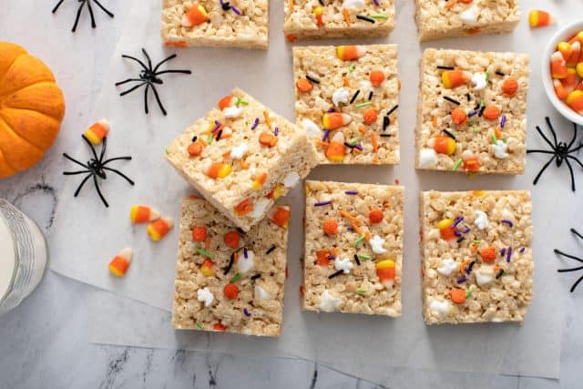 Rice cereal treats for Halloween with candy corn and festive sprinkles overhead view, flat lay