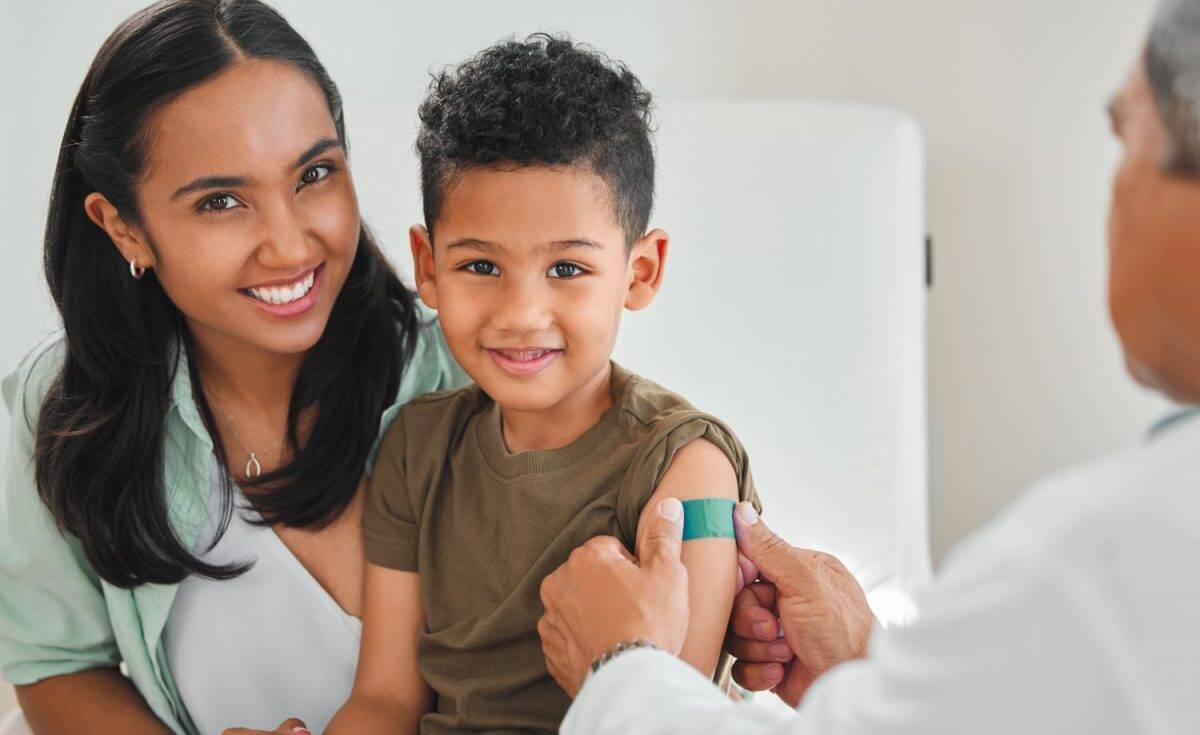 Pediatrician, woman and child with portrait, plaster and vaccine for growth or development in clinic. Mother, boy and doctor with health at hospital for immunity, routine check and illness prevention