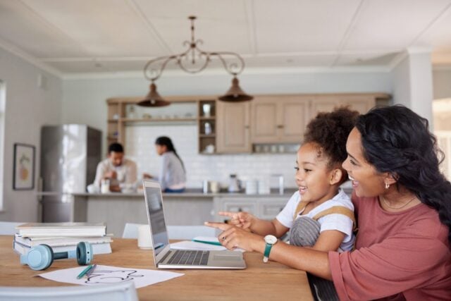 Mother, girl or happy with laptop in home for learning, education or homeschool lesson with remote work. People, mom or daughter with technology for study activity, pointing or support in dining room