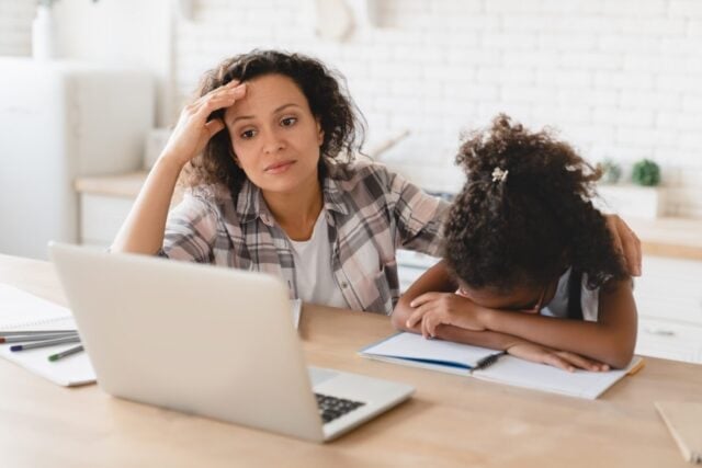 School problems. Homeschooling. African-american mother helping assisting daughter with homework, school load. Tutor explaining hard difficult task to a student with laptop. Distant e-learning