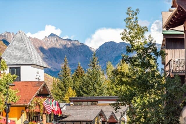 Vail, Colorado ski resort town with cityscape of lodge hotel buildings in swiss architecture and mountain peak in autumn fall season