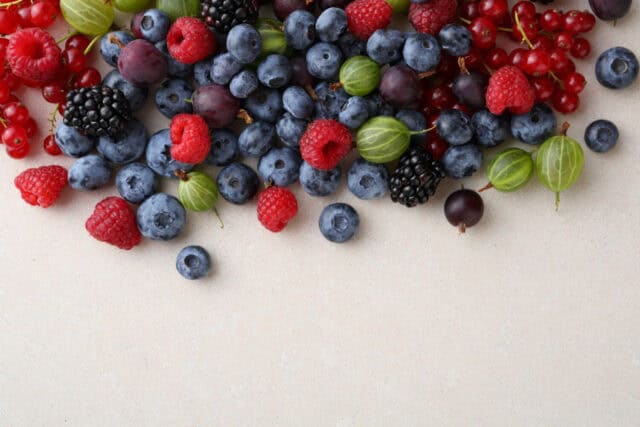 Fresh berries mix on concrete background, food top view