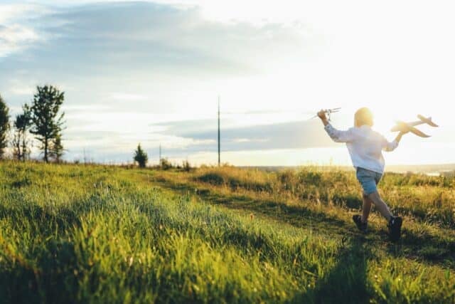 Child on a field at sunset, happy childhood.